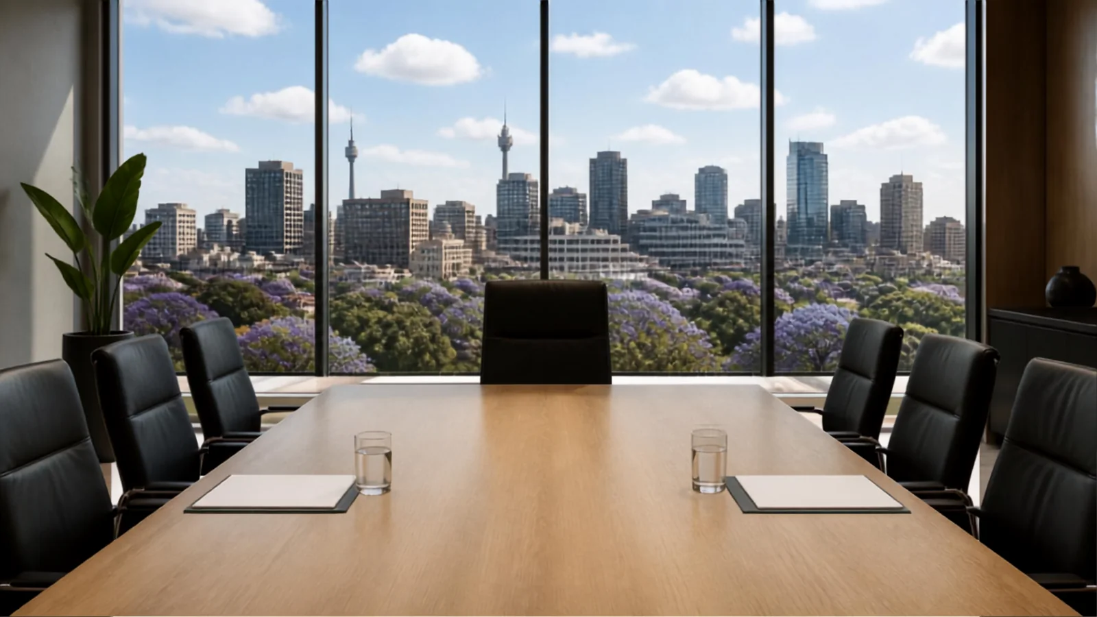 A boardroom set for a commercial mediation, overlooking a Johannesburg skyline with jacarandas in flower