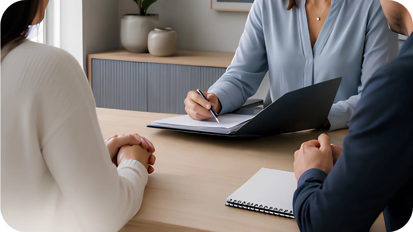 A parenting coordinator taking notes with a parent at a consultation table